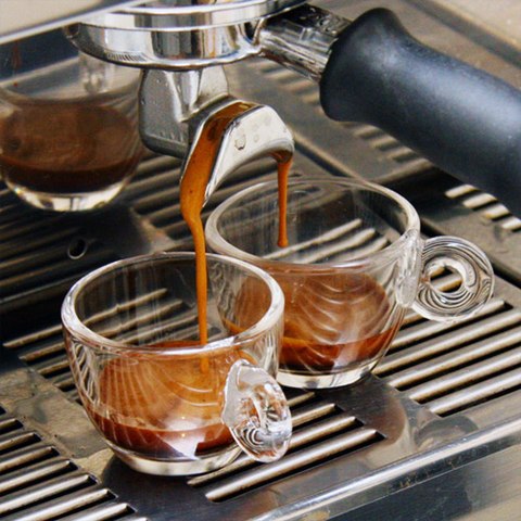 Two shots of espresso being pulled from an espresso
machine